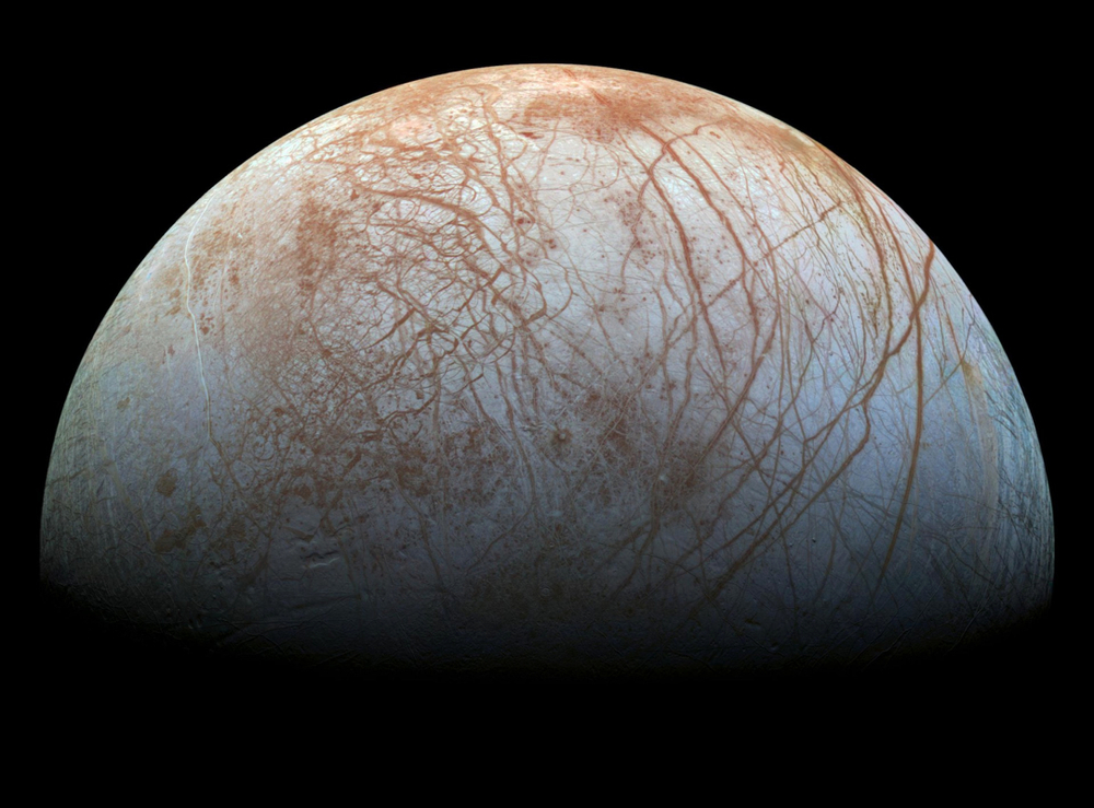 With an icy surface, Europa orbits Jupiter